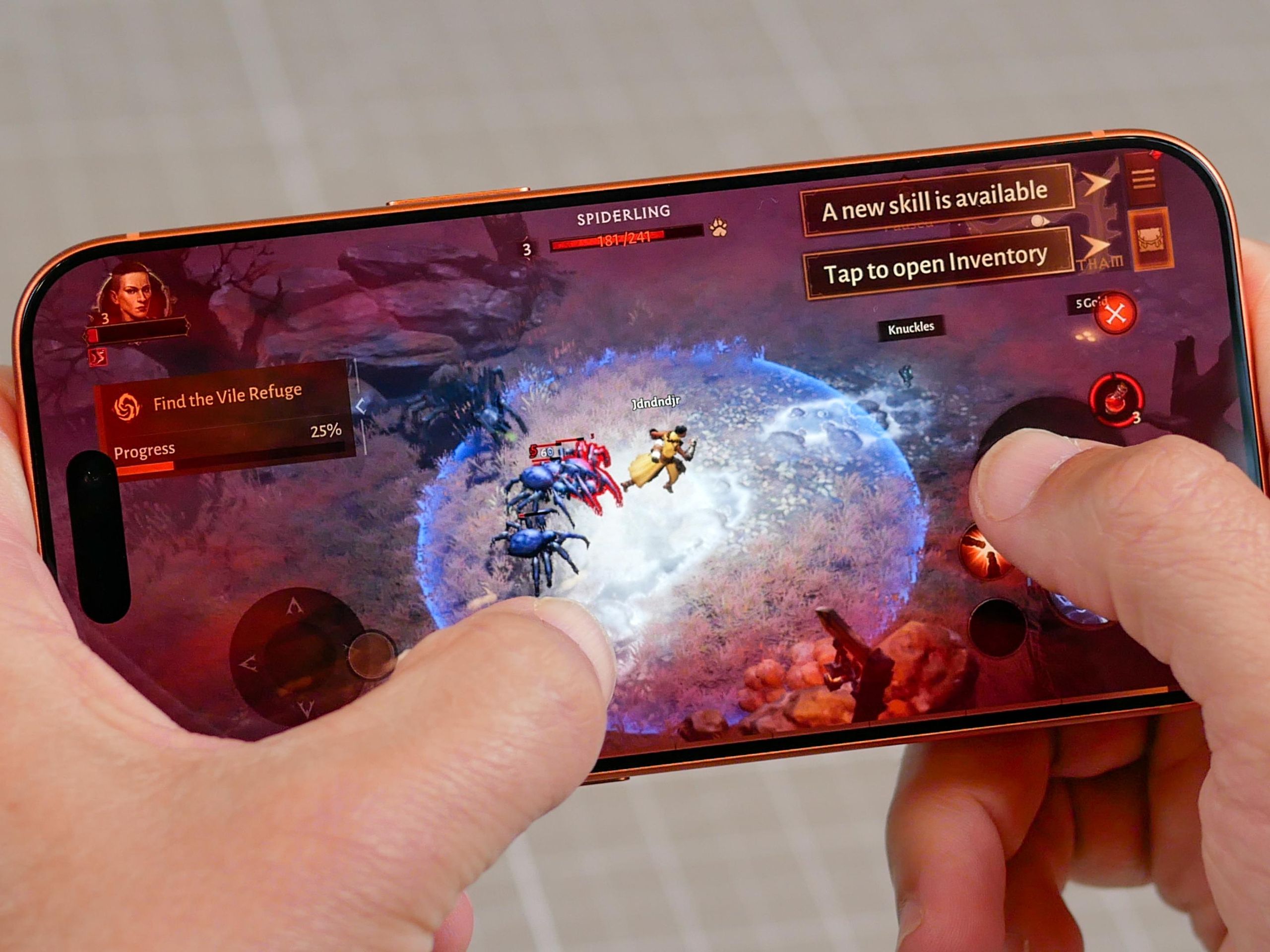 Smartphone displaying a fictional mobile game at an Australian gaming technology exhibition